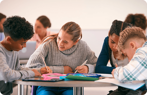 Students working on projects together at a classroom table