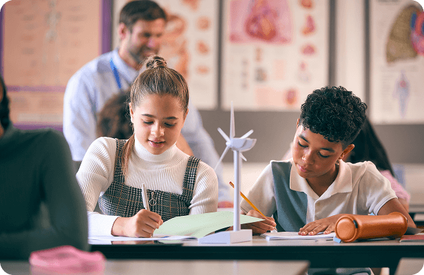 Students working on a science project with a teacher