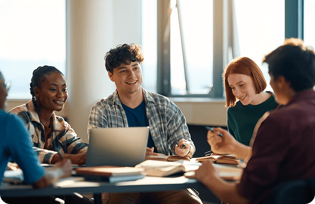 Students talking around a table in a classroom