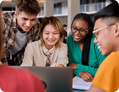 Students leaning in together around a laptop
